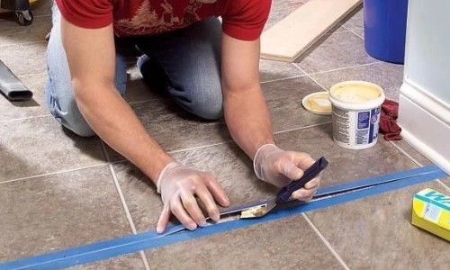 Apply adhesive under the tile