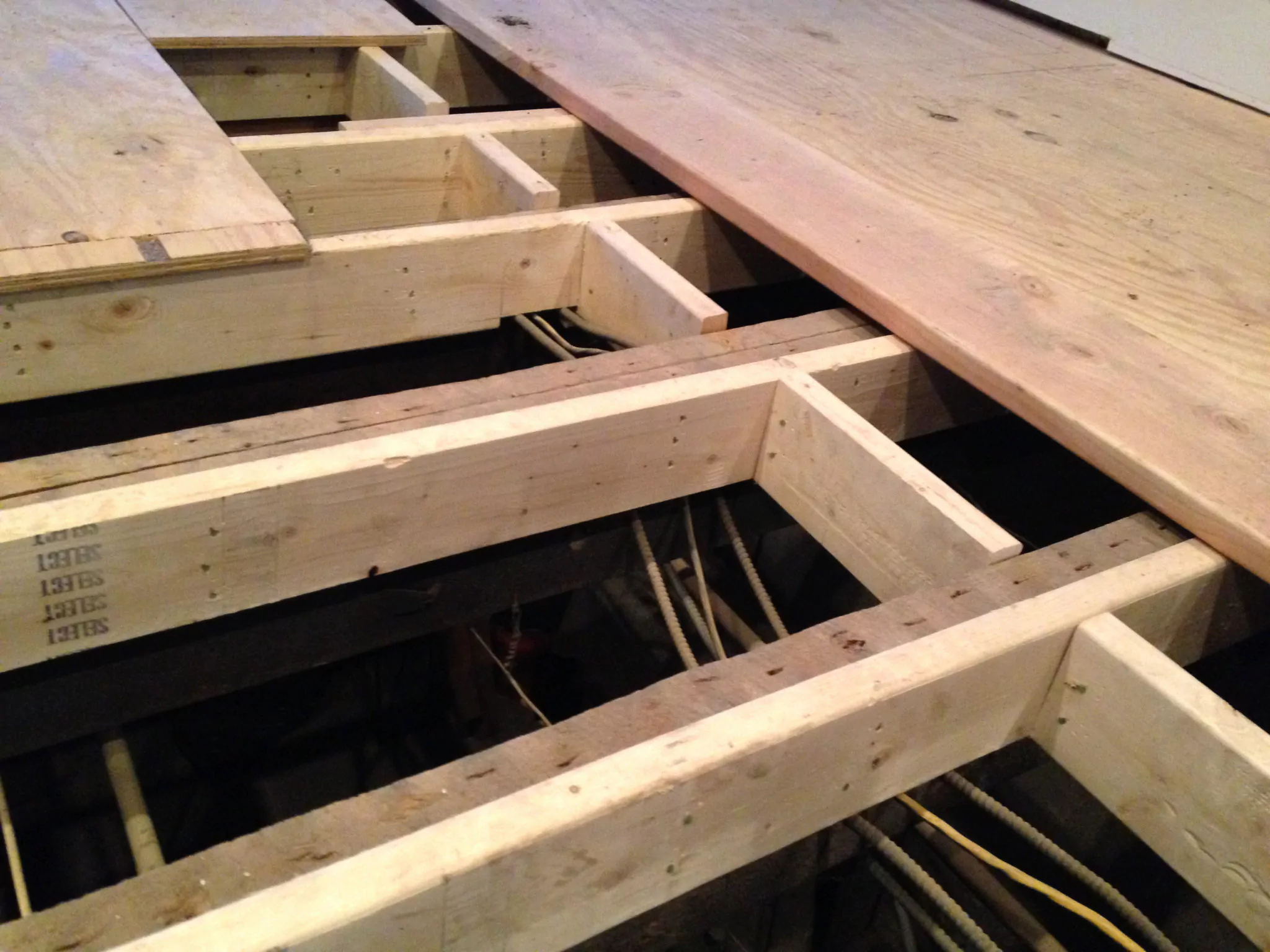 The beams and floor joists below the floor may have deteriorated, leading to sagging and dipping
